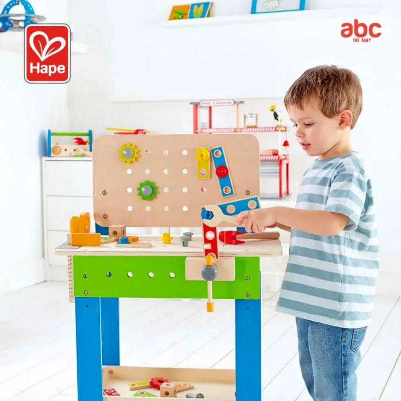 Child playing with wooden tool toys, tightening nuts and screws