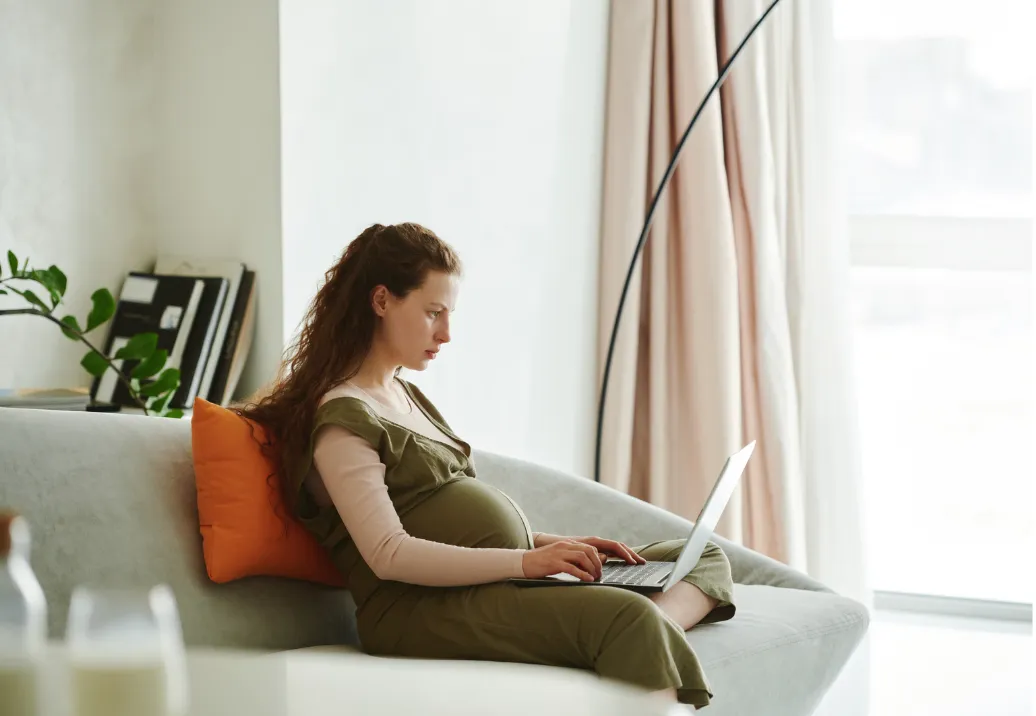 Pregnant woman adjusting her sitting posture