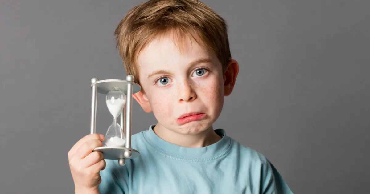 A child protecting their eyes during screen use