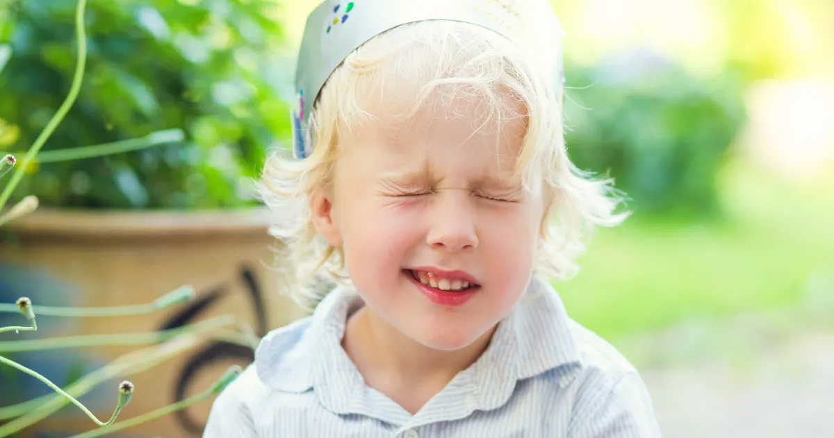 A child protecting their eyes during screen use