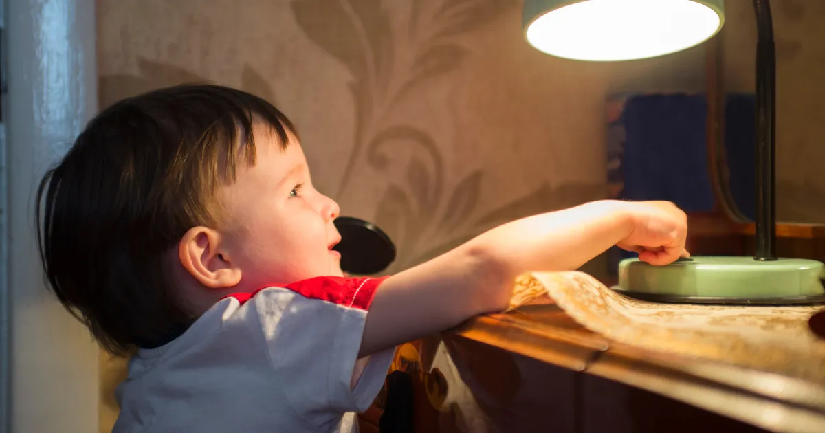 A child protecting their eyes during screen use