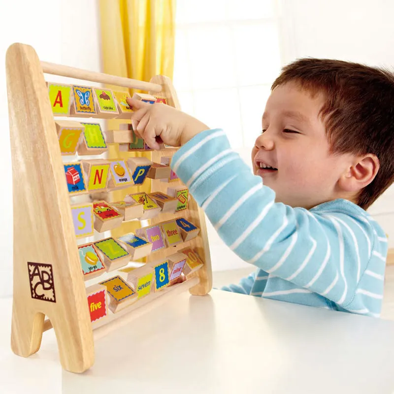 A child playing with wooden toys arranged in rotating sets